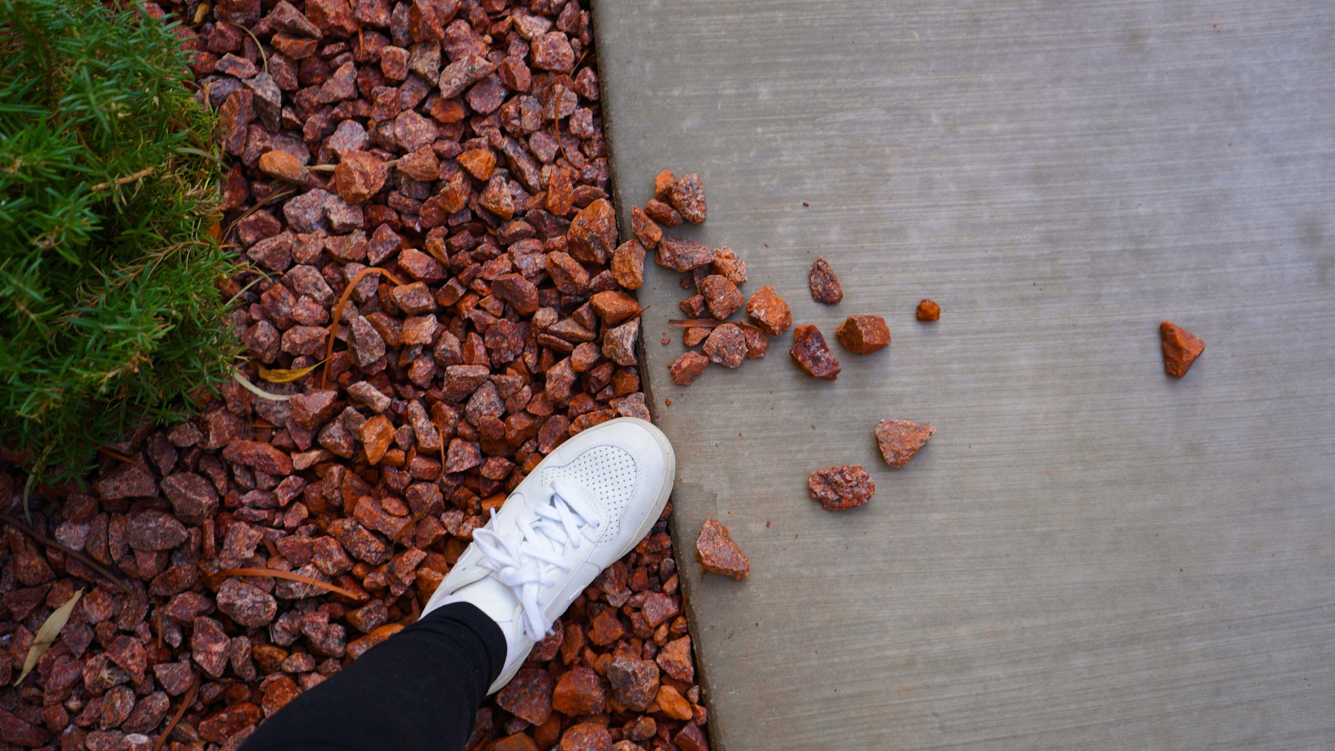 Shoe kicking stones 